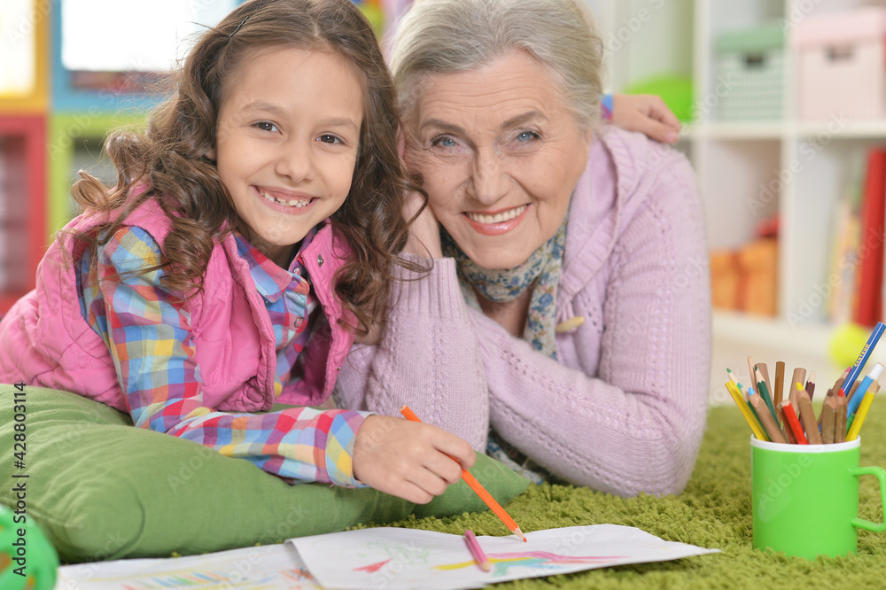 Fototapeta premium grandmother and granddaughter drawing together