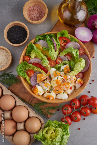 Diet menu. Healthy salad of fresh vegetables - tomatoes, egg, Onion. high angle view of a nutritious vegetable salad with boiled egg slices, served.  Healthy meal concept.