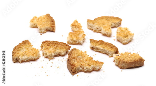 Broken rusks pile, broken pieces with crumbs with crumbs isolated on white background