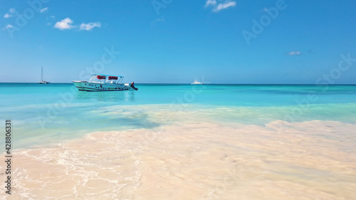 Ship floating in bright turquoise water. View of endless sea in tropical destination. Exotic vacation in Dominican Republic. © CameraCraft