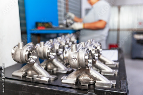 Production of vehicle part in the automotive industry, blurred worker at work in the factory