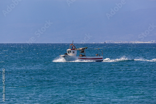 Fishing boat comes back to the coast, Almeria, Spain.