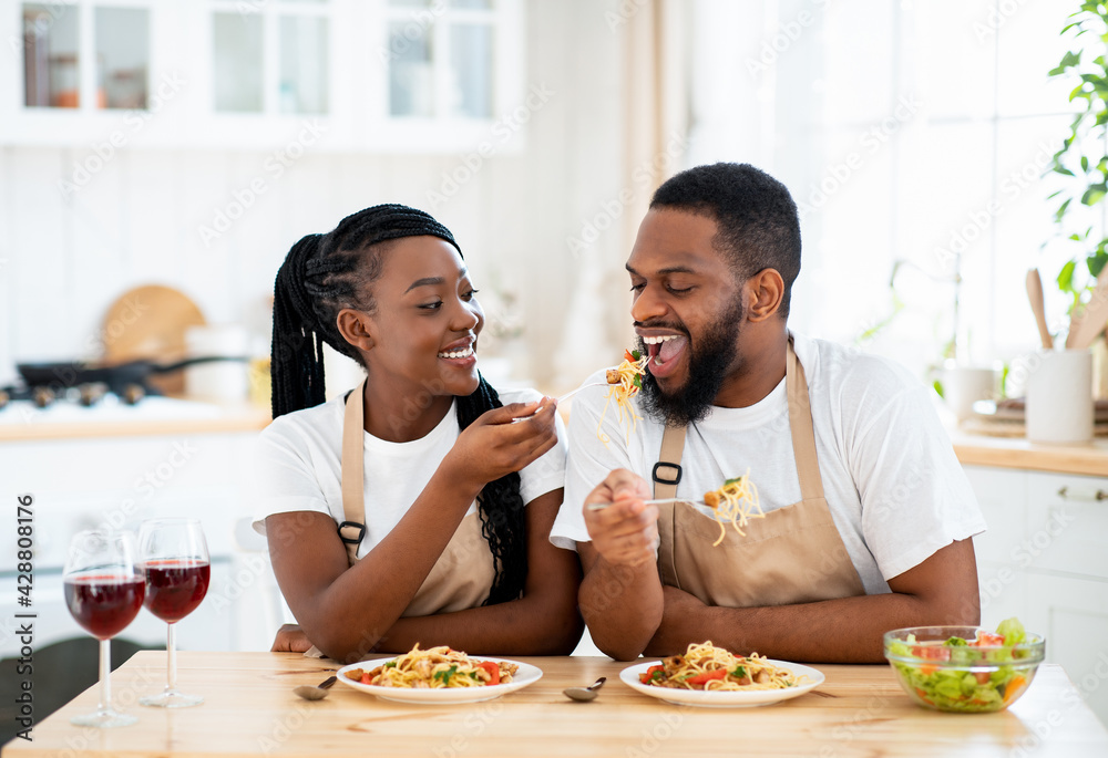 Happy Black Spouses Eating Lunch At Home, Enjoying Spaghetti And Wine Happy Black Spouses Eating Lunch At Home, Enjoying Spaghetti And Wine