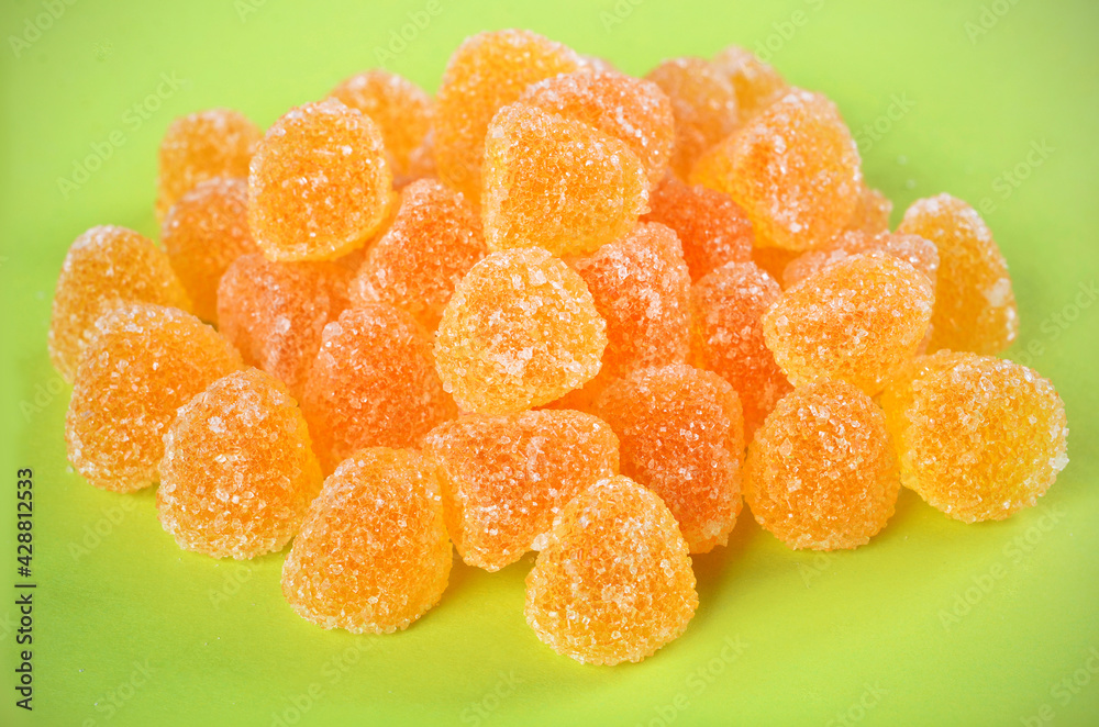 fruit jelly candies on a green background fruit jelly candies on a green background