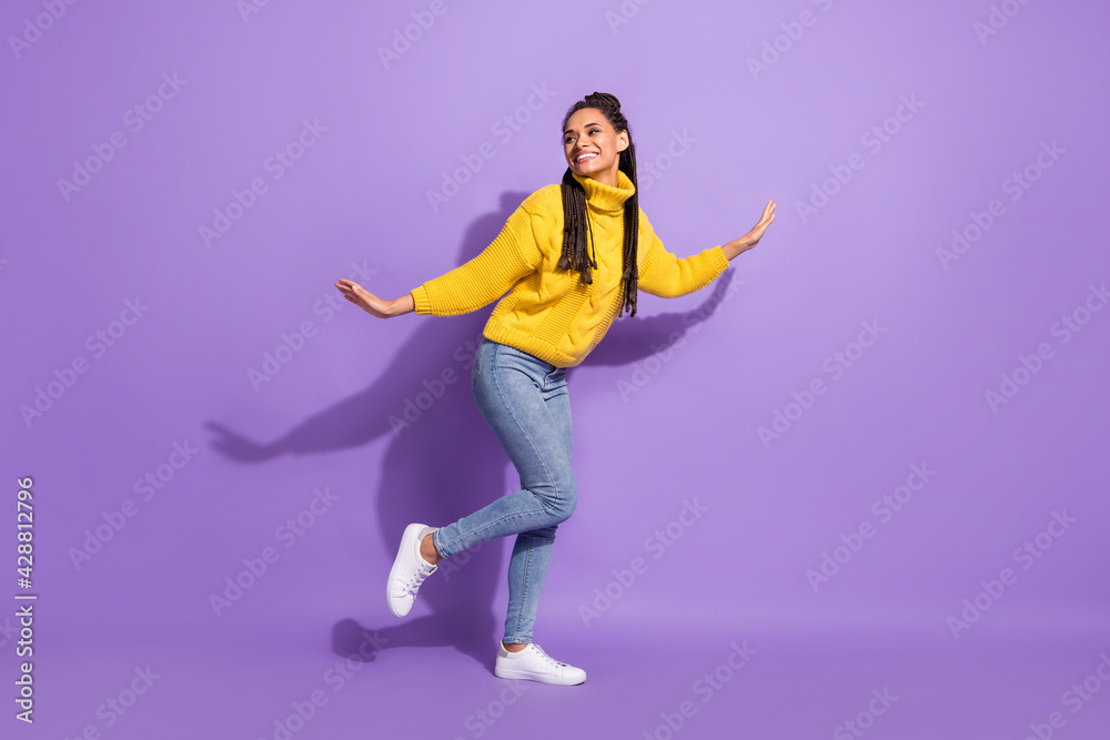 Full size profile photo of optimistic nice brunette girl dance wear sweater jeans isolated on purple background