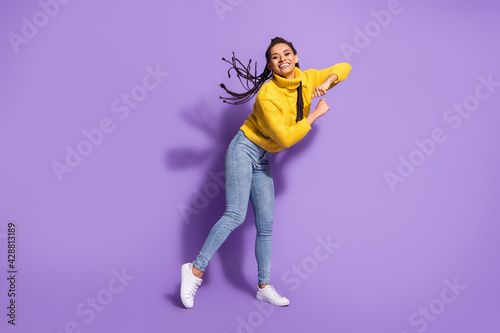 Photo portrait of woman showing cool dance moves isolated on vivid purple colored background