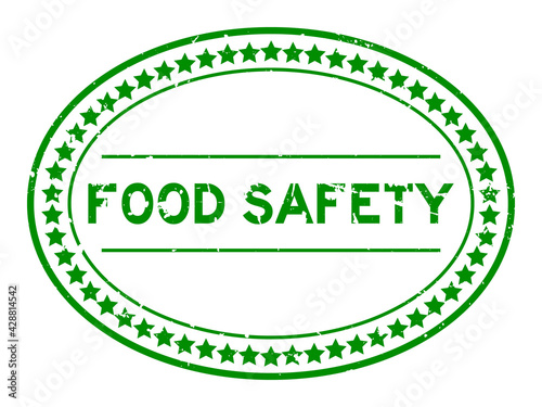 Grunge green food safety word oval rubber seal stamp on white background
