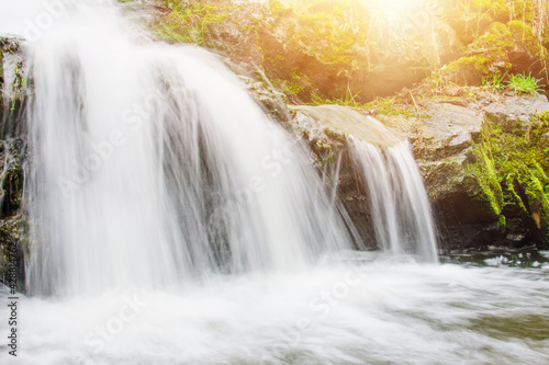 Waterfall on the river in the rocks during sunny day. Tourism concept.