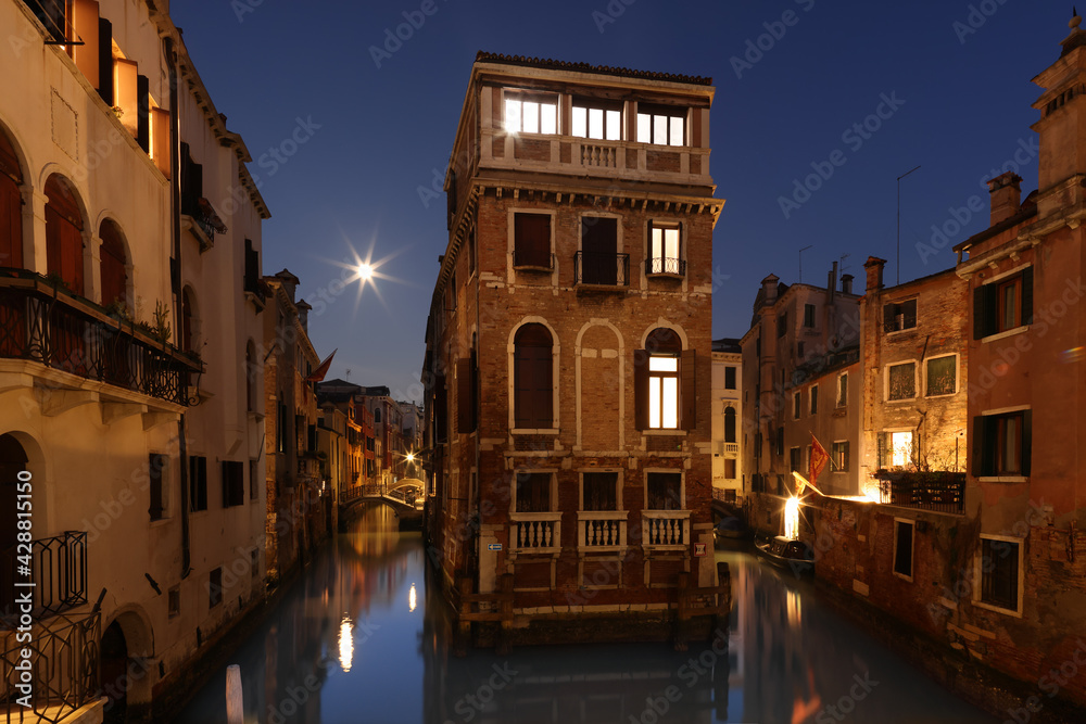 Floating house and canal in Castello, Venice, Italy