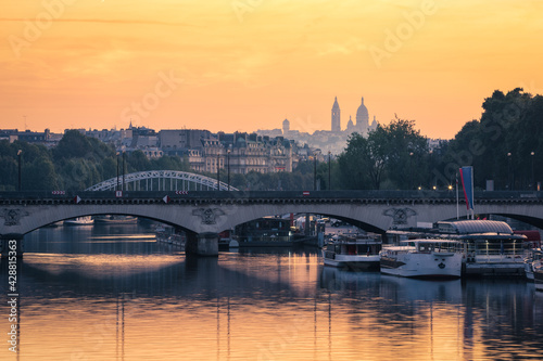 Paris, The Basilica of the Sacred Heart (Sacré-Cœur Basilica) and the Seine river at sunrise. Pont de Bir-Hakeim, Paris, France