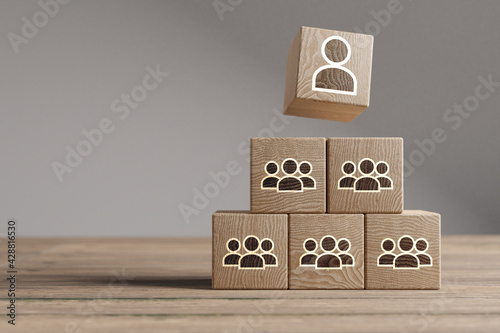 Wood cubes with new head of team or CEO on a beautiful wooden table, studio background. Business concept and copy space.