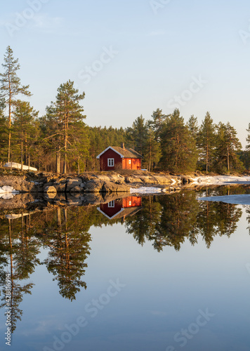 Typical Scandinavian-style holiday home in a forest by the lake called hytte