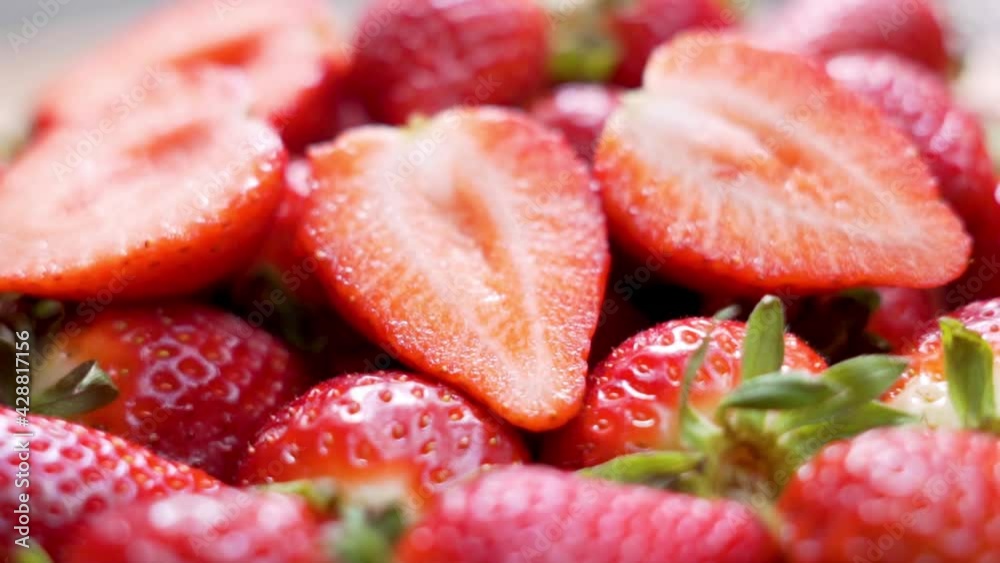 Red Raspberry Juicy Strawberries and Strawberry Halves, Close-up. Delicious Summer Berries. Background of Strawberry Slices and Fresh-Harvest Strawberries. Natural Healthy Vegan Food. Red Raspberry Juicy Strawberries and Strawberry Halves, Close-up. Delicious Summer Berries. Background of Strawberry Slices and Fresh-Harvest Strawberries. Natural Healthy Vegan Food.
