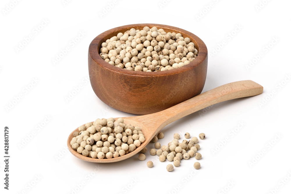White peppercorns (white pepper) in wooden bowl and spoon isolated on white background. White peppercorns (white pepper) in wooden bowl and spoon isolated on white background.
