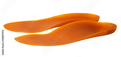 Orange medical insoles isolated on a white background with clipping path. Insert in shoes to support the foot. Orthotics 