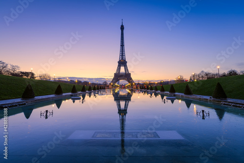 Frozen reflections in Paris. Eiffel Tower at sunrise from Trocadero Fountains 