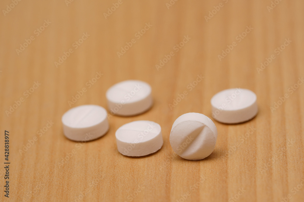 White pills on the table. Selective focus. White pills on the table. Selective focus.