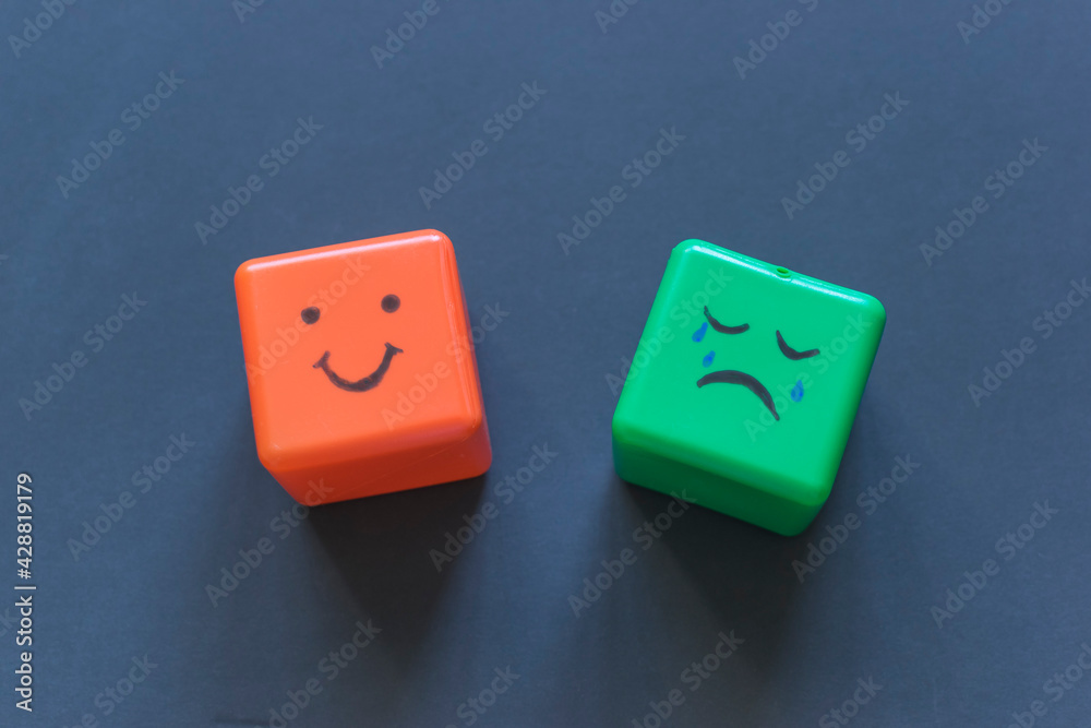 Positive and negative emotions concept, funny faces drawn on cubes. Positive and negative emotions concept, funny faces drawn on cubes.