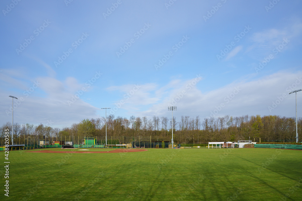 View of an empty baseball field from centerfield. Sky with light clouds.