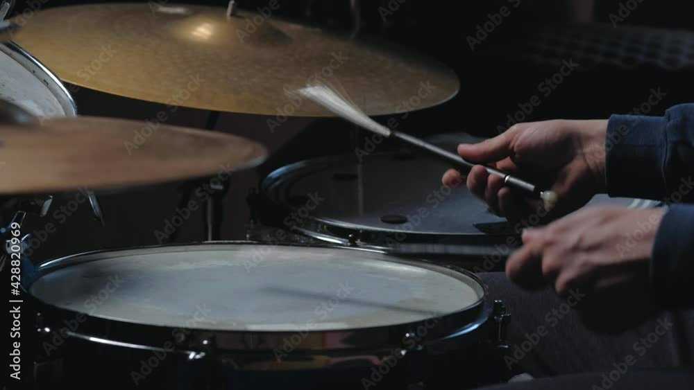 unrecognizable male jazz drummer playing at drums. isolated on black background. Close up shot. Home lesson training.