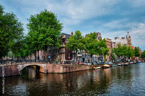 Amsterdam view - canal with boad, bridge and old houses © Dmitry Rukhlenko