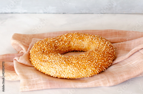 Simit Turkish crispy braided bagel with sesame seeds. Turkish homemade traditional pastries. Side view. Close-up. Copy space.