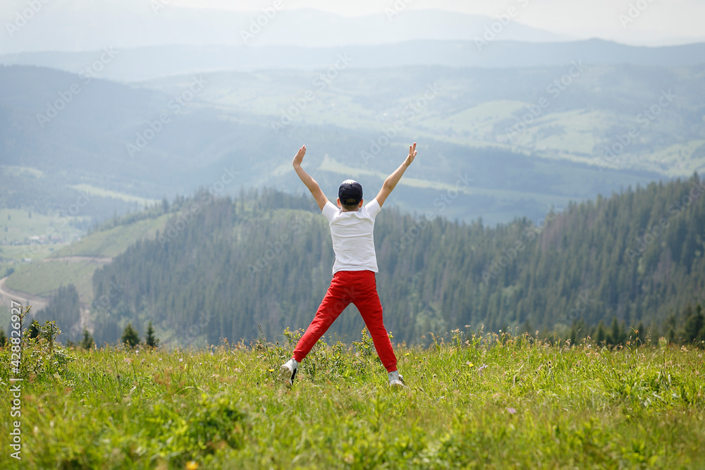 a boy jumps on top of a mountain for joy to feel freedom and from the beauty he saw a boy jumps on top of a mountain for joy to feel freedom and from the beauty he saw