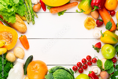 Fototapeta Naklejka Na Ścianę i Meble -  Vegetables, fruits assortment frame on white wooden background. Vegetarian healthy food concept. Food and grocery shopping. Free space