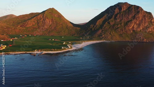 Wide Aerial View of Sunny Uttakleiv Beach, Mountains and Calm Oceanic Waters photo