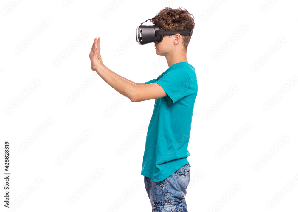 Portrait of young caucasian teen boy using virtual reality goggles. Funny teenager looking in VR glasses. Handsome child experiencing 3D gadget technology, isolated on white background Portrait of young caucasian teen boy using virtual reality goggles. Funny teenager looking in VR glasses. Handsome child experiencing 3D gadget technology, isolated on white background