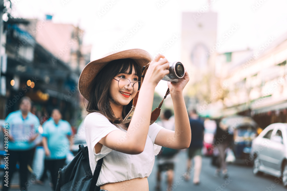 Young adult asian cute woman wear eyeglasses traveller backpack with camera solo local travel.