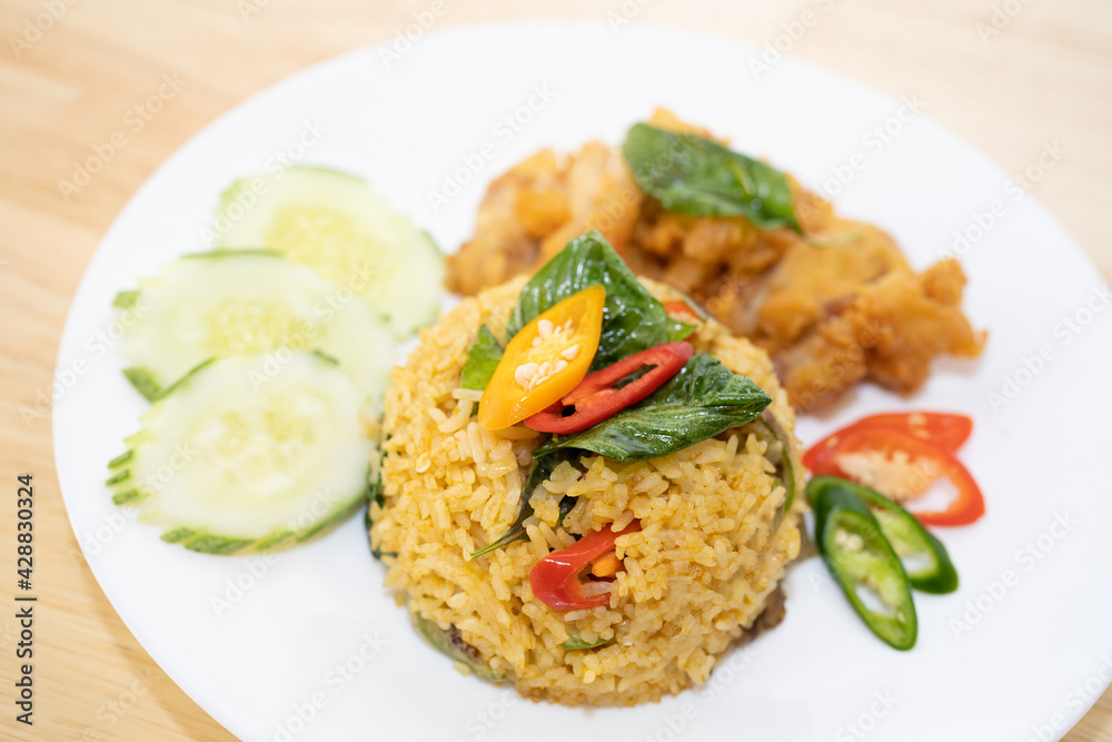 Green curry fried rice with fried chicken. Green curry fried rice with fried chicken.
