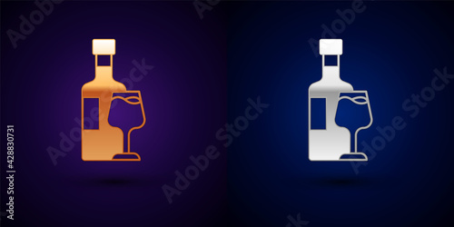 Gold and silver Wine bottle with glass icon isolated on black background. Vector