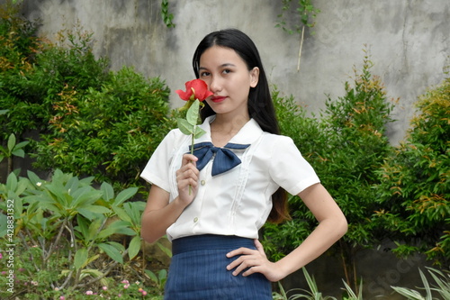Unemotional Youthful Filipina Person With Flower