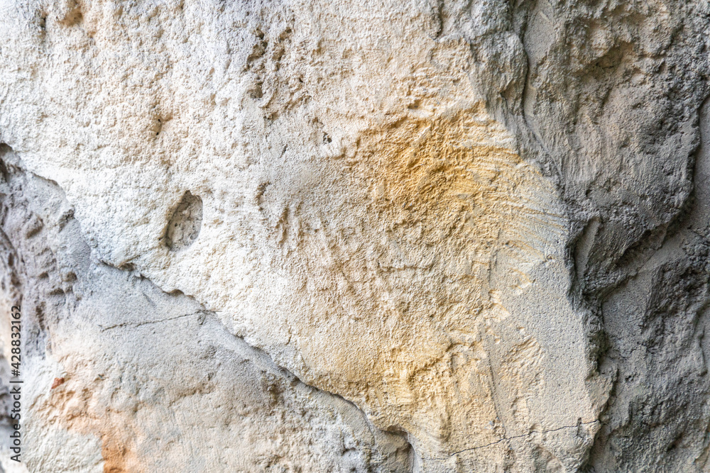 Naklejka premium Rough stone as a pattern for background, stone background, rocky texture