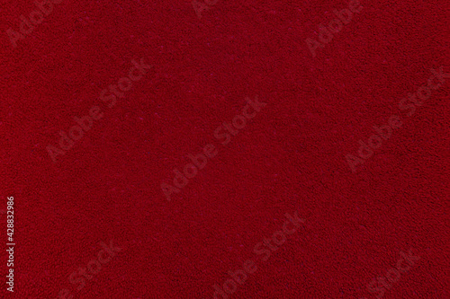 Textile background. Red velvet or corduroy. An empty and flat surface.
