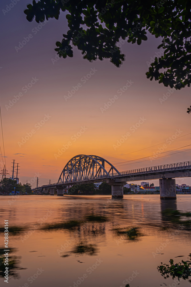 Obraz premium Beautiful sunset on Binh Loi Bridge new and old by night in the rush hour, Ho Chi Minh City, Vietnam.