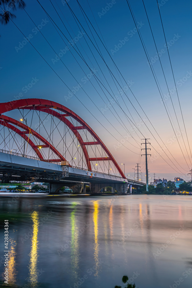 Obraz premium Beautiful sunset on Binh Loi Bridge new and old by night in the rush hour, Ho Chi Minh City, Vietnam.