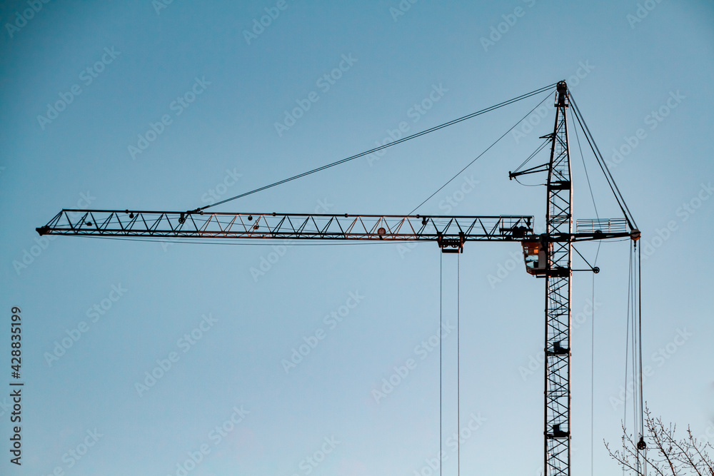 building a tower crane against the sky