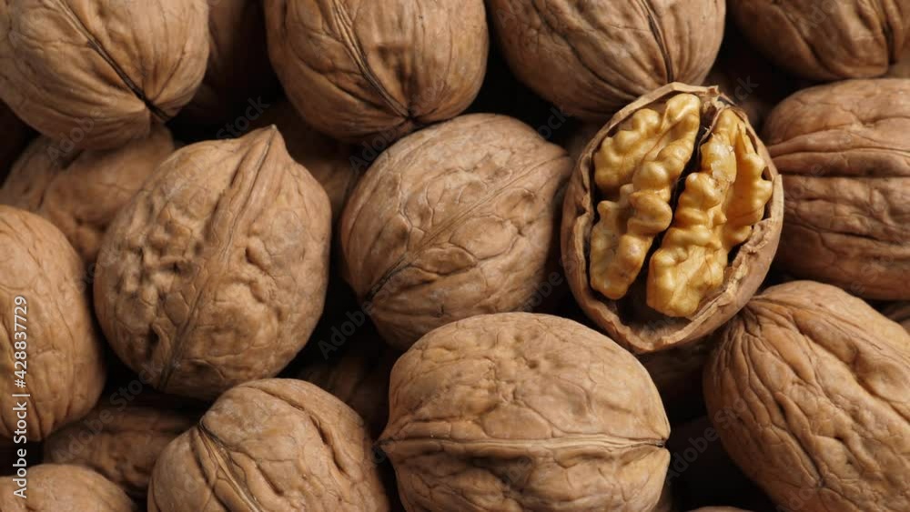 Whole Walnut closeup. Rotating nuts background, nobody Whole Walnut closeup. Rotating nuts background, nobody