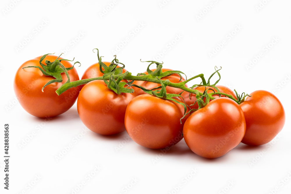 Cherry tomatoes are isolated on a white background.