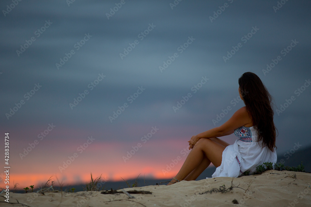young girl contemplating the sunset young girl contemplating the sunset