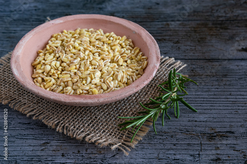 Uncooked wheat grains grown in france on rustic background