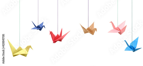 Hanging colorful origami paper birds on white