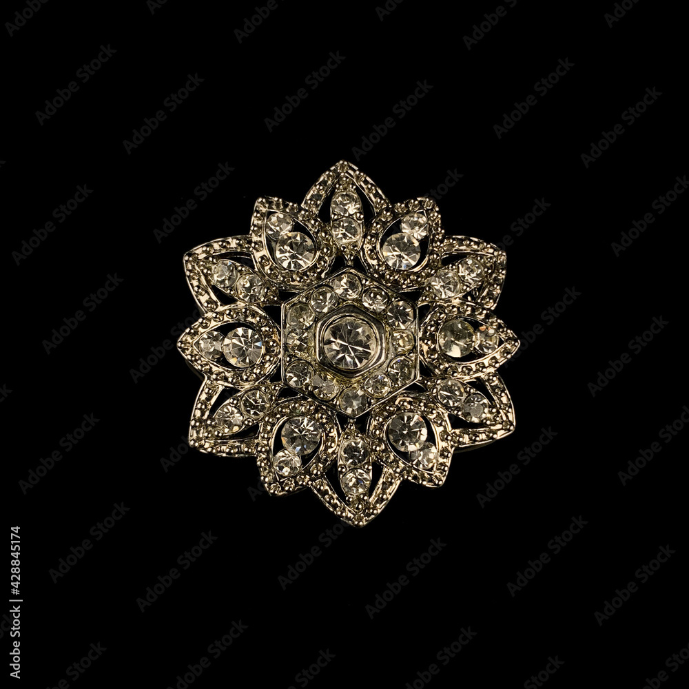 Round antique brooch with precious stones and crystals in the shape of a flower. Vintage brooch in the shape of a flower Round antique brooch with precious stones and crystals in the shape of a flower. Vintage brooch in the shape of a flower