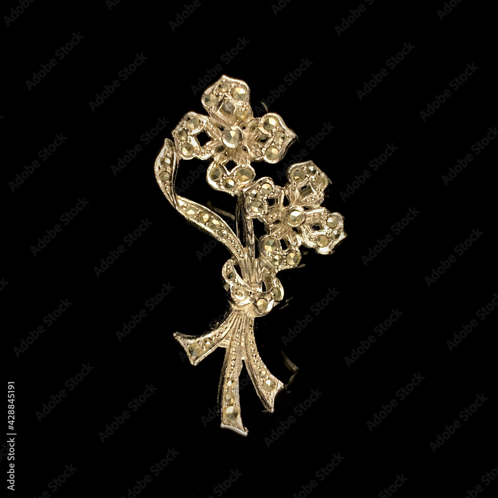 Round antique brooch with precious stones and crystals in the shape of a flower. Vintage brooch in the shape of a flower Round antique brooch with precious stones and crystals in the shape of a flower. Vintage brooch in the shape of a flower