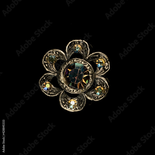 Round antique brooch with a flower shape. Vintage brooch in the shape of a flower