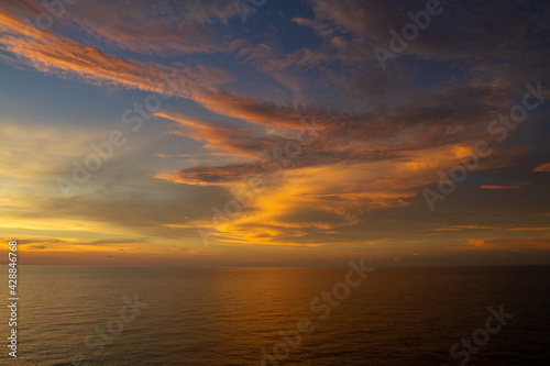 Beautiful ocean view with a dramatic cloudy sky golden sunset