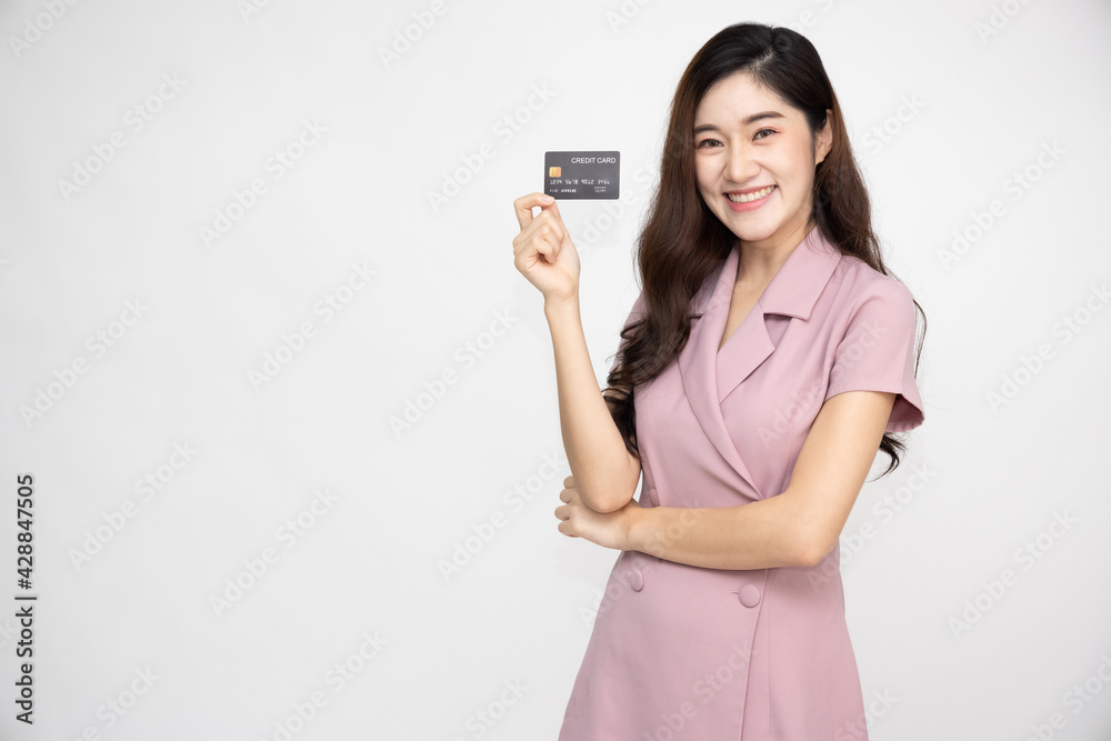 Young beautiful Asian woman smiling, showing, presenting credit card for making payment or paying online business, Pay a merchant or as a cash advance for goods, Cardholder or A person who owns a card Young beautiful Asian woman smiling, showing, presenting credit card for making payment or paying online business, Pay a merchant or as a cash advance for goods, Cardholder or A person who owns a card