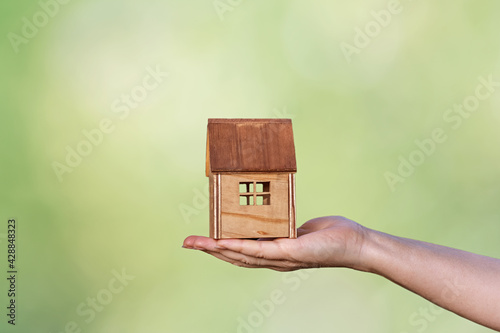 Model house in the gardenhold by hand photo